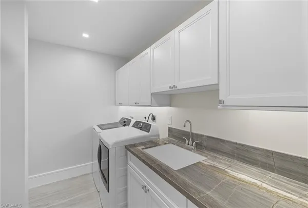 a room with a sink and cabinets