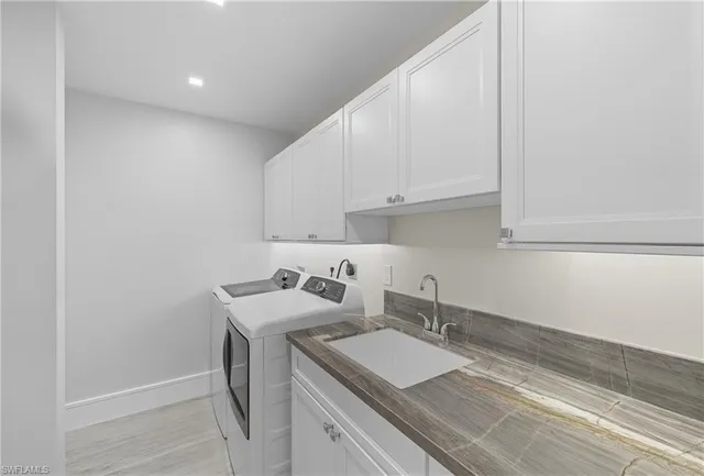 a room with a sink and cabinets