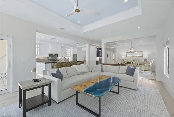 a living room with furniture and view of kitchen