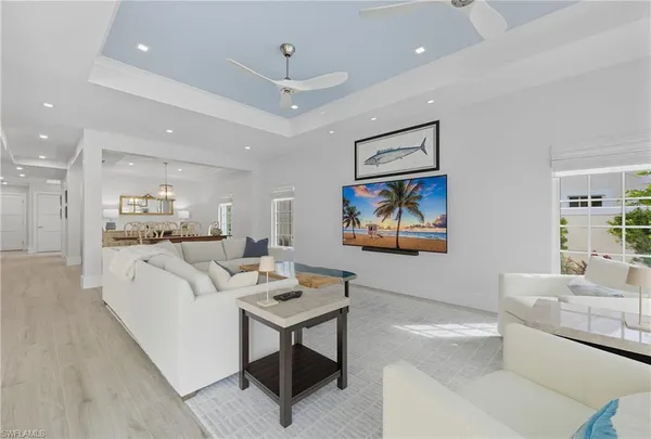 a living room with furniture a couch and kitchen view