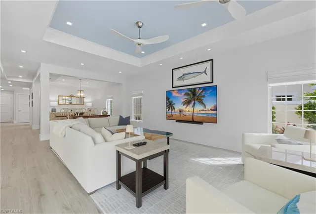 a living room with furniture a couch and kitchen view