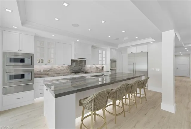 a large kitchen with stainless steel appliances lots of counter space and breakfast area