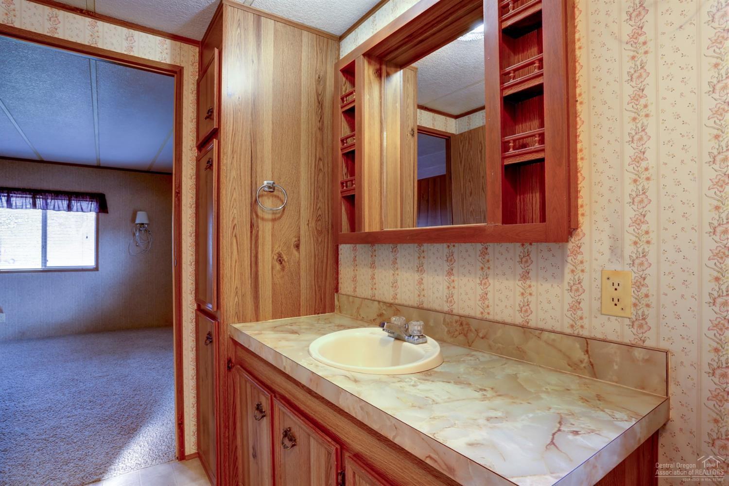 65040 Hunnell Road Bend, OR 97703 - Photo 8 of 25 a bathroom with a sink and a mirror