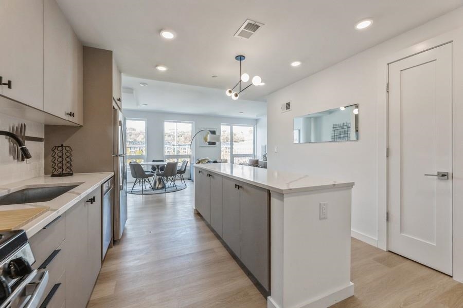 401 Jackson Street, Unit 507 Hoboken, NJ 07030 - Photo 12 of 29 a large white kitchen with lots of counter space
