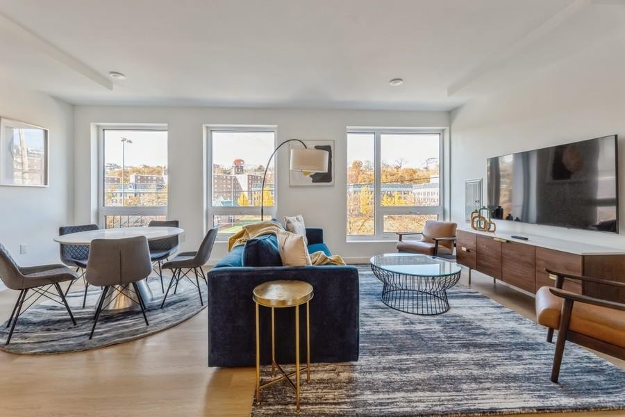 401 Jackson Street, Unit 507 Hoboken, NJ 07030 - Photo 13 of 29 a living room with furniture and a flat screen tv