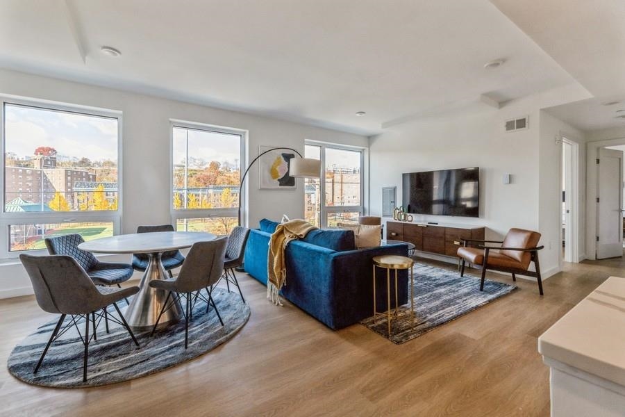 401 Jackson Street, Unit 507 Hoboken, NJ 07030 - Photo 14 of 29 a living room with furniture and a flat screen tv