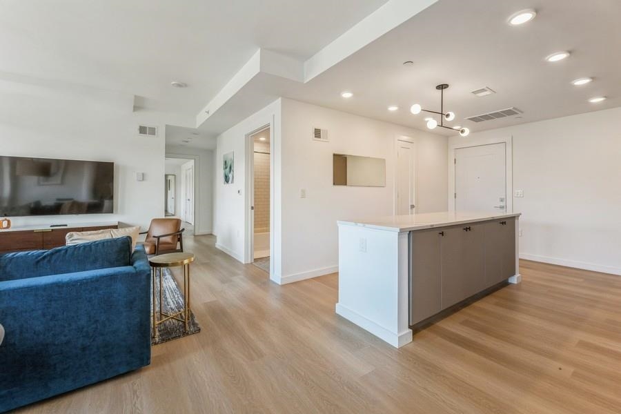 401 Jackson Street, Unit 507 Hoboken, NJ 07030 - Photo 16 of 29 a view of kitchen with cabinets and flat screen tv