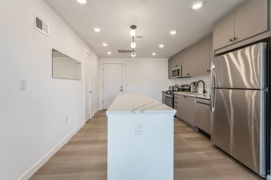 401 Jackson Street, Unit 507 Hoboken, NJ 07030 - Photo 17 of 29 a kitchen with a refrigerator a sink and dishwasher
