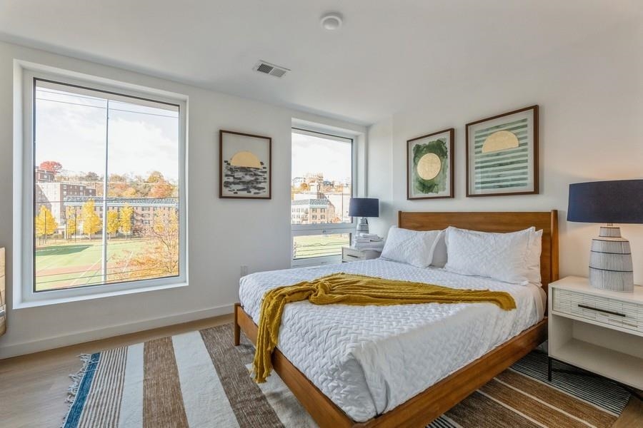 401 Jackson Street, Unit 507 Hoboken, NJ 07030 - Photo 18 of 29 a bedroom with a bed and next to a window