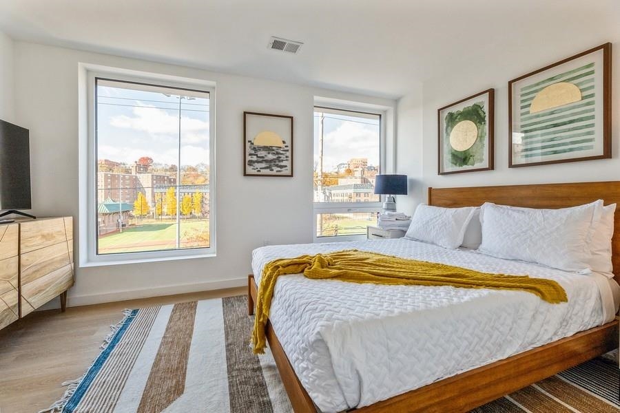 401 Jackson Street, Unit 507 Hoboken, NJ 07030 - Photo 19 of 29 a bed sitting in a bedroom next to a window