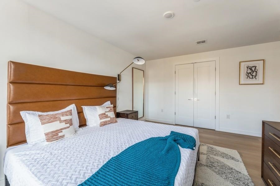 401 Jackson Street, Unit 507 Hoboken, NJ 07030 - Photo 22 of 29 a bedroom with a bed and a painting on the wall