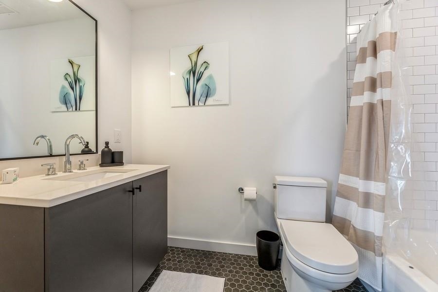 401 Jackson Street, Unit 507 Hoboken, NJ 07030 - Photo 23 of 29 a bathroom with a toilet a sink and mirror