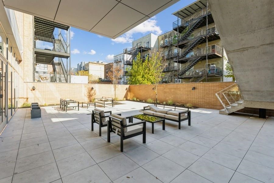401 Jackson Street, Unit 507 Hoboken, NJ 07030 - Photo 7 of 29 a view of a patio with dining table and chairs