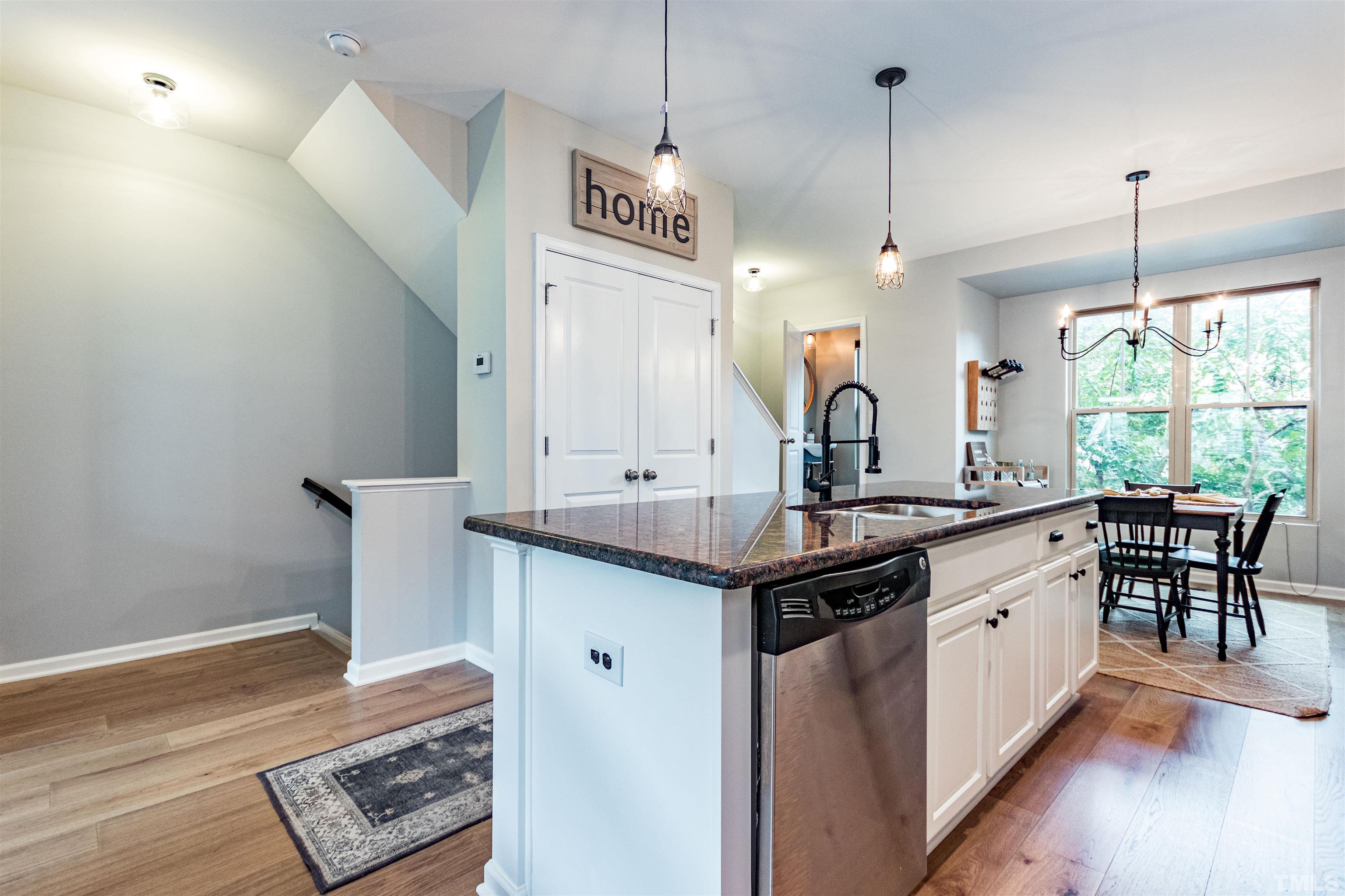 1417 Crafton Way Raleigh, NC 27607 - Photo 10 of 29 a kitchen with stainless steel appliances granite countertop a sink a stove and a wooden floor