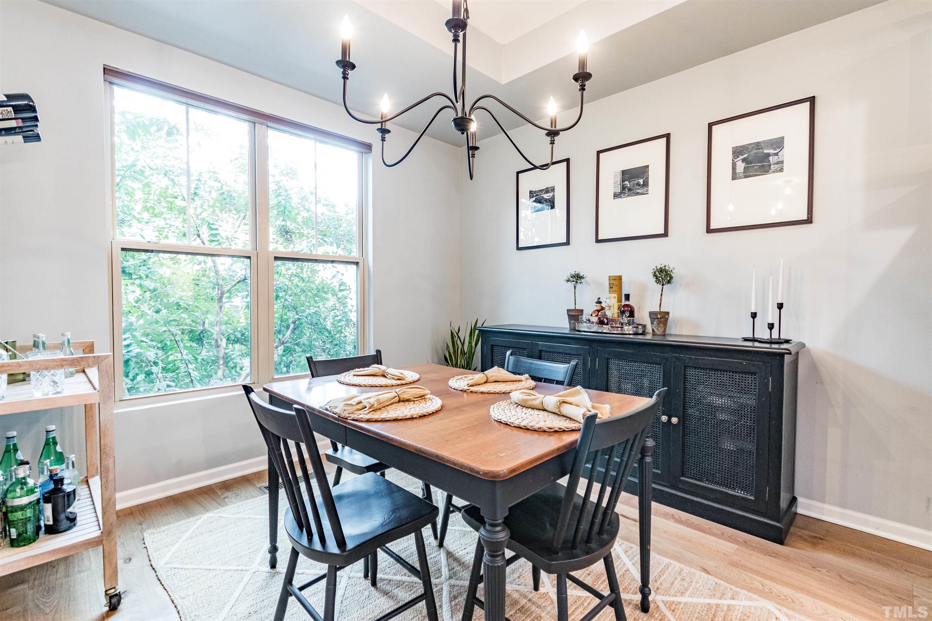 1417 Crafton Way Raleigh, NC 27607 - Photo 12 of 29 a view of a dining room with furniture window and wooden floor