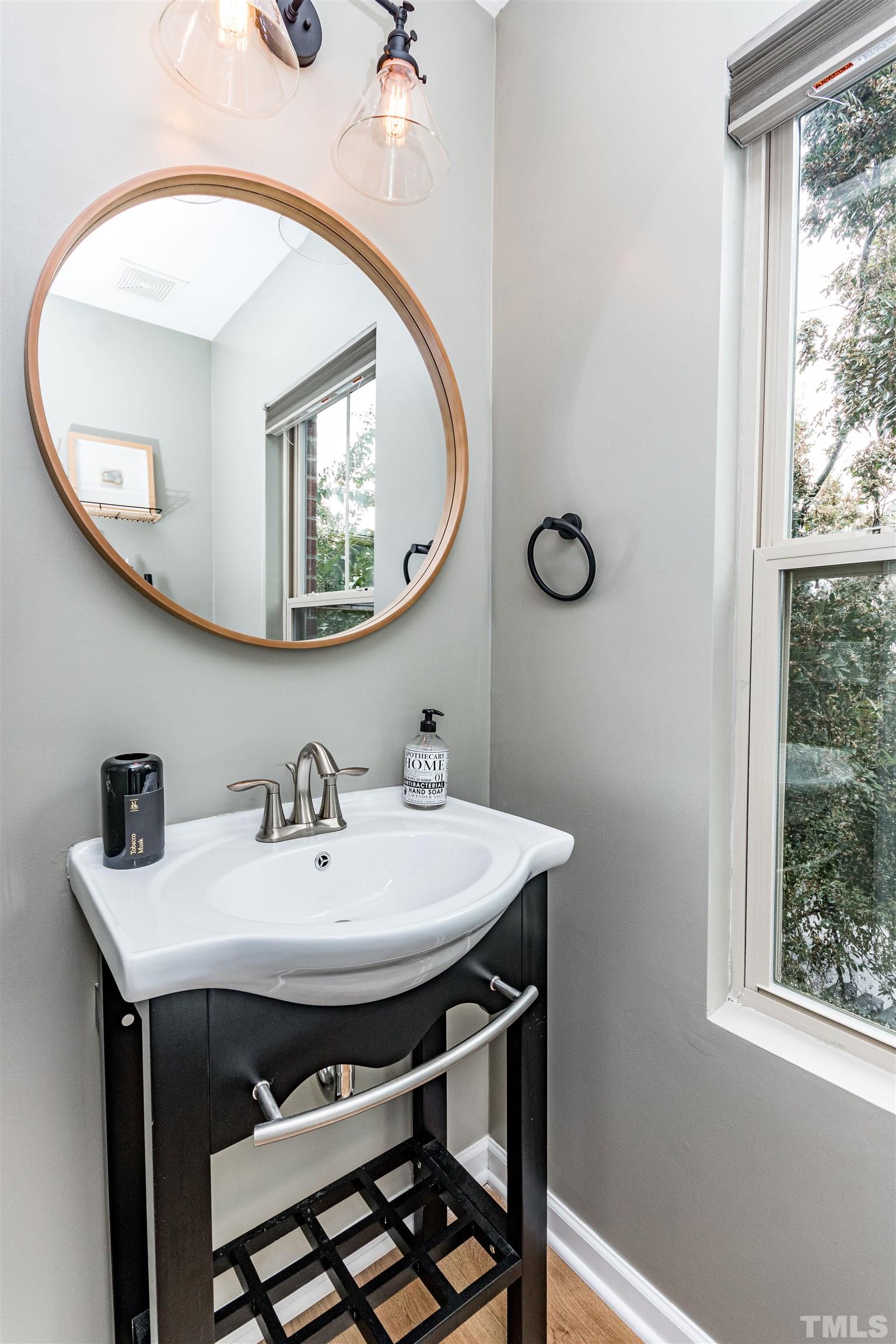 1417 Crafton Way Raleigh, NC 27607 - Photo 14 of 29 a bathroom with a sink a mirror and a window