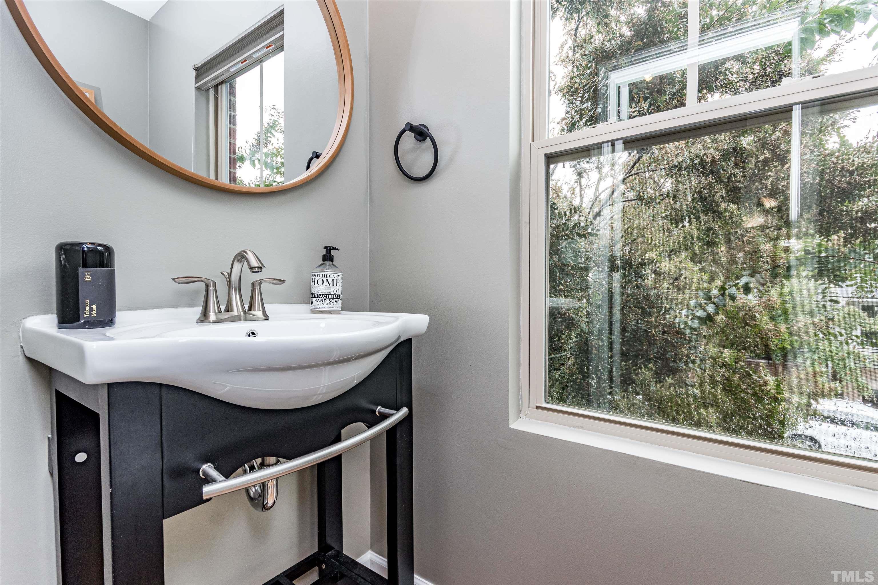 1417 Crafton Way Raleigh, NC 27607 - Photo 15 of 29 a bathroom with a sink and a mirror