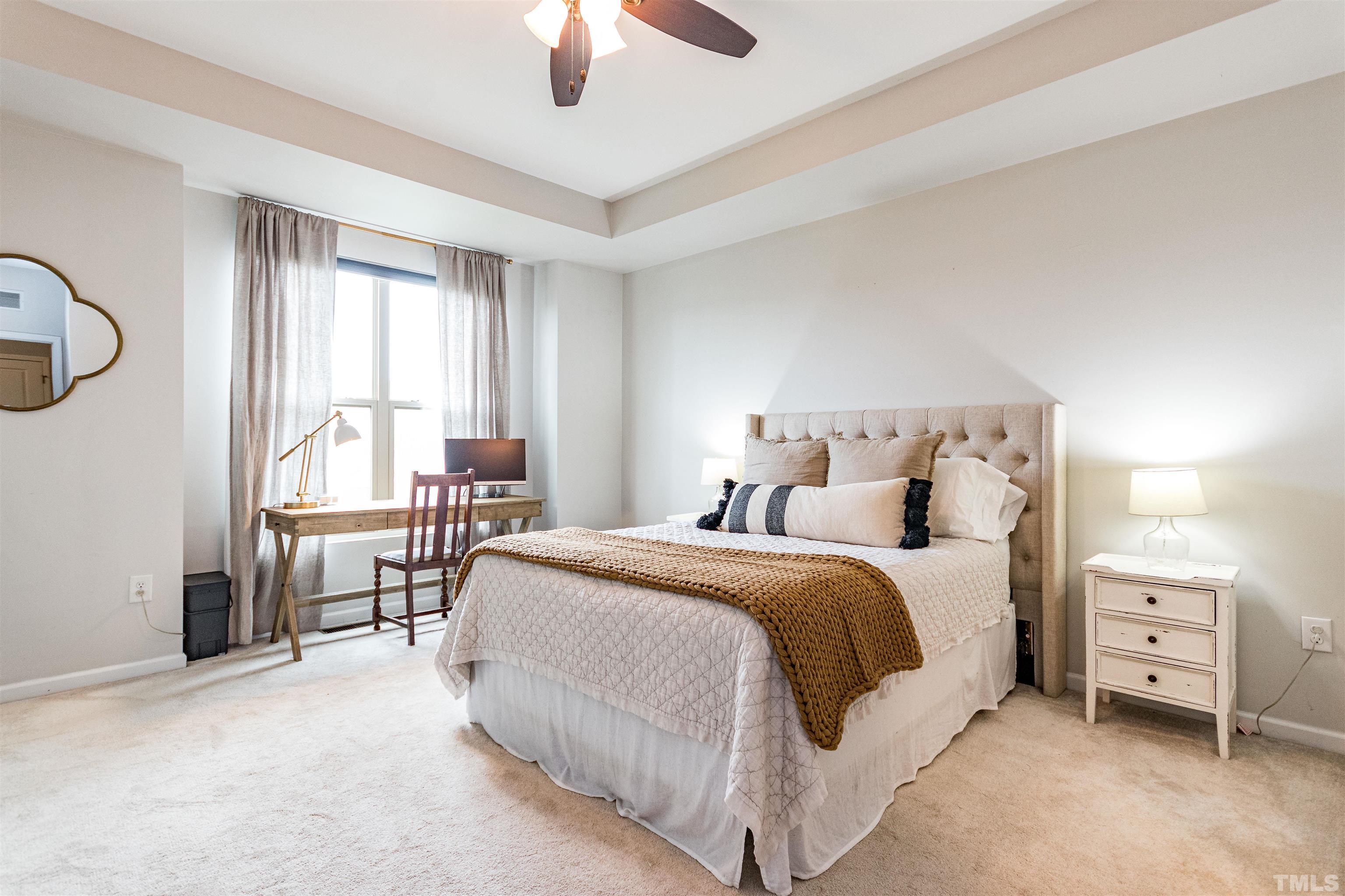 1417 Crafton Way Raleigh, NC 27607 - Photo 17 of 29 a spacious bedroom with a bed a table and chair