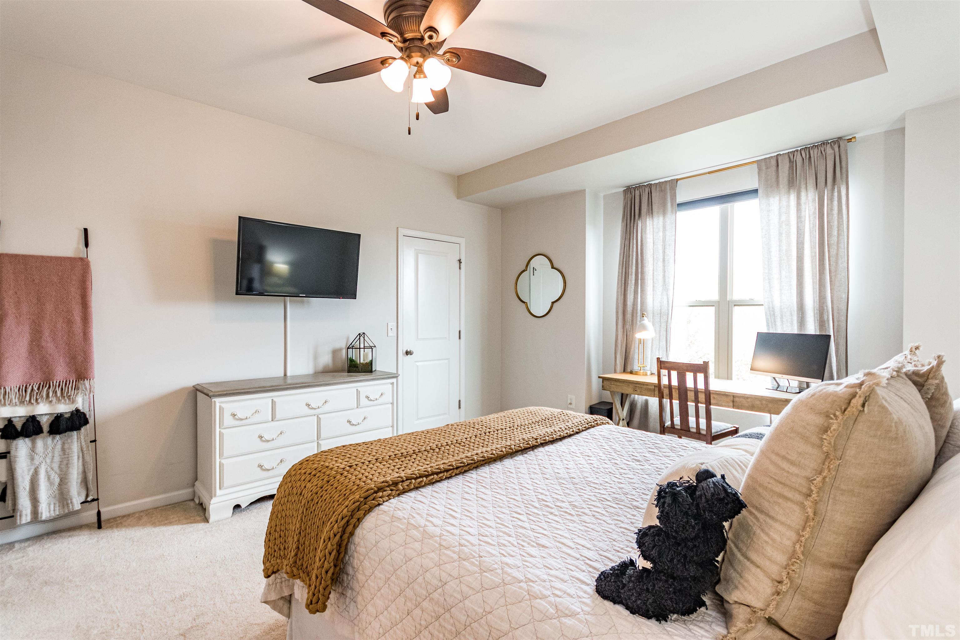 1417 Crafton Way Raleigh, NC 27607 - Photo 18 of 29 a bedroom with a bed and a flat screen tv