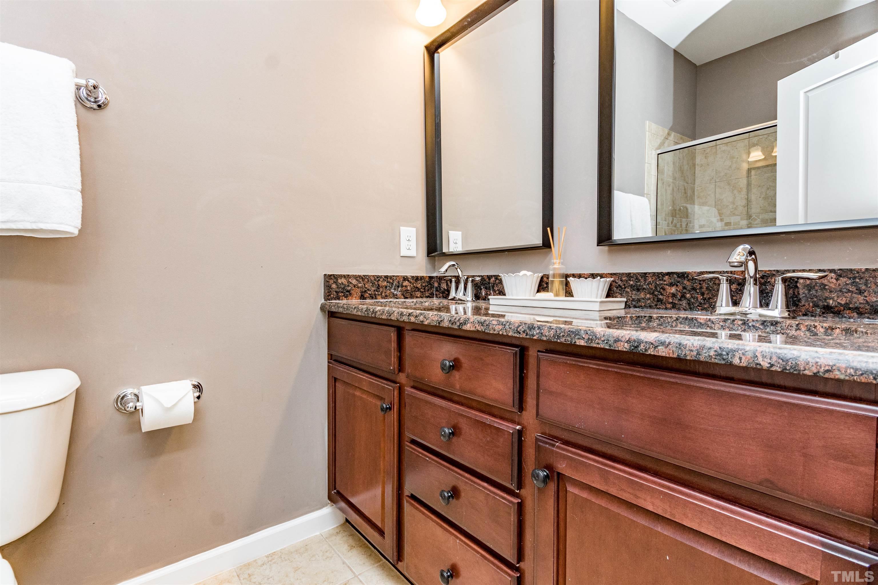 1417 Crafton Way Raleigh, NC 27607 - Photo 21 of 29 a bathroom with a granite countertop sink and a mirror