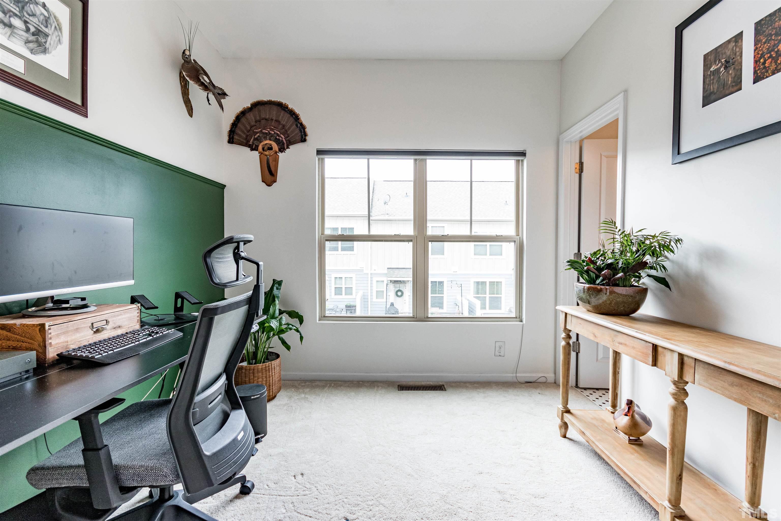 1417 Crafton Way Raleigh, NC 27607 - Photo 23 of 29 a view of a room with gym equipment and windows