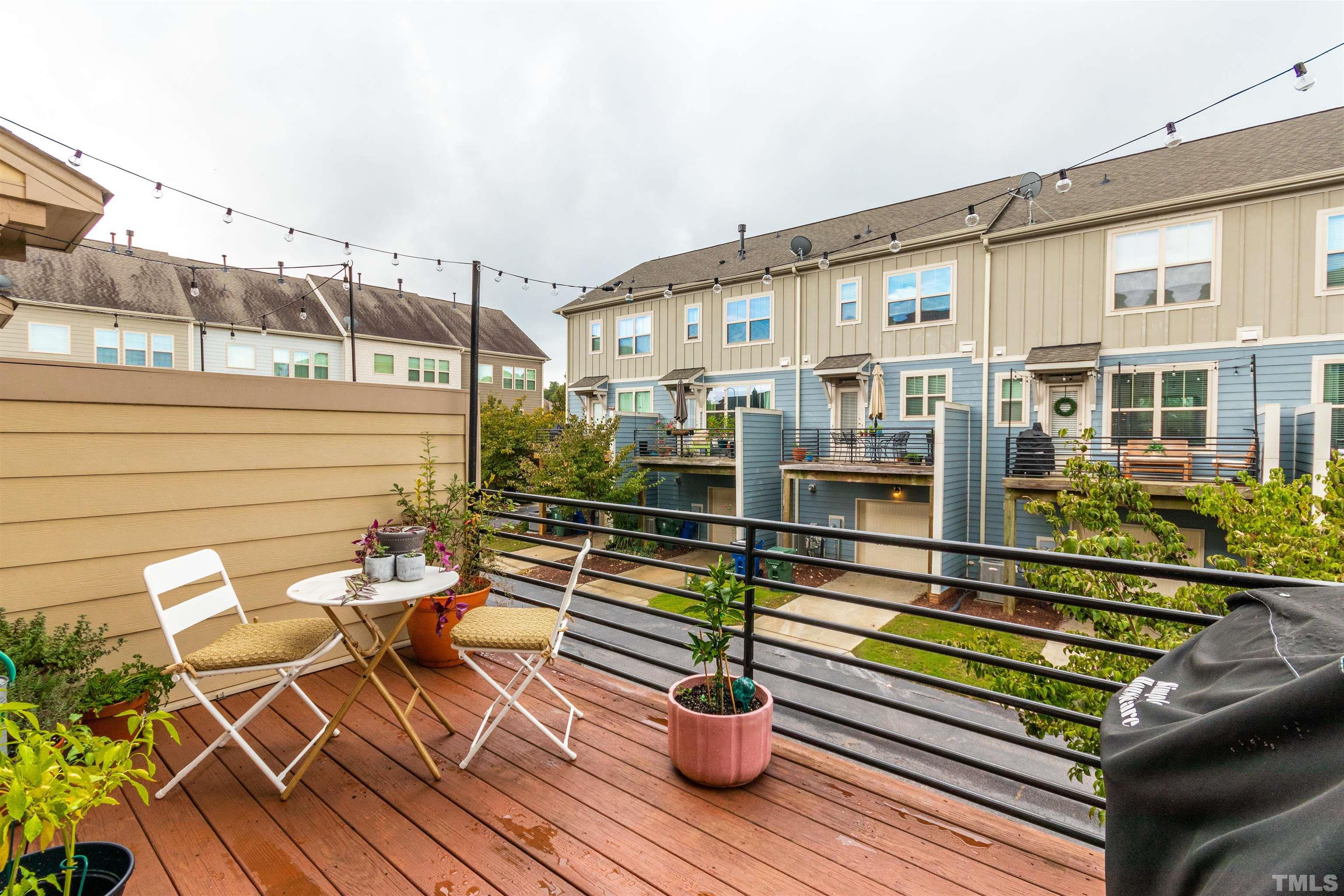 1417 Crafton Way Raleigh, NC 27607 - Photo 26 of 29 a view of a balcony with chairs and wooden floor