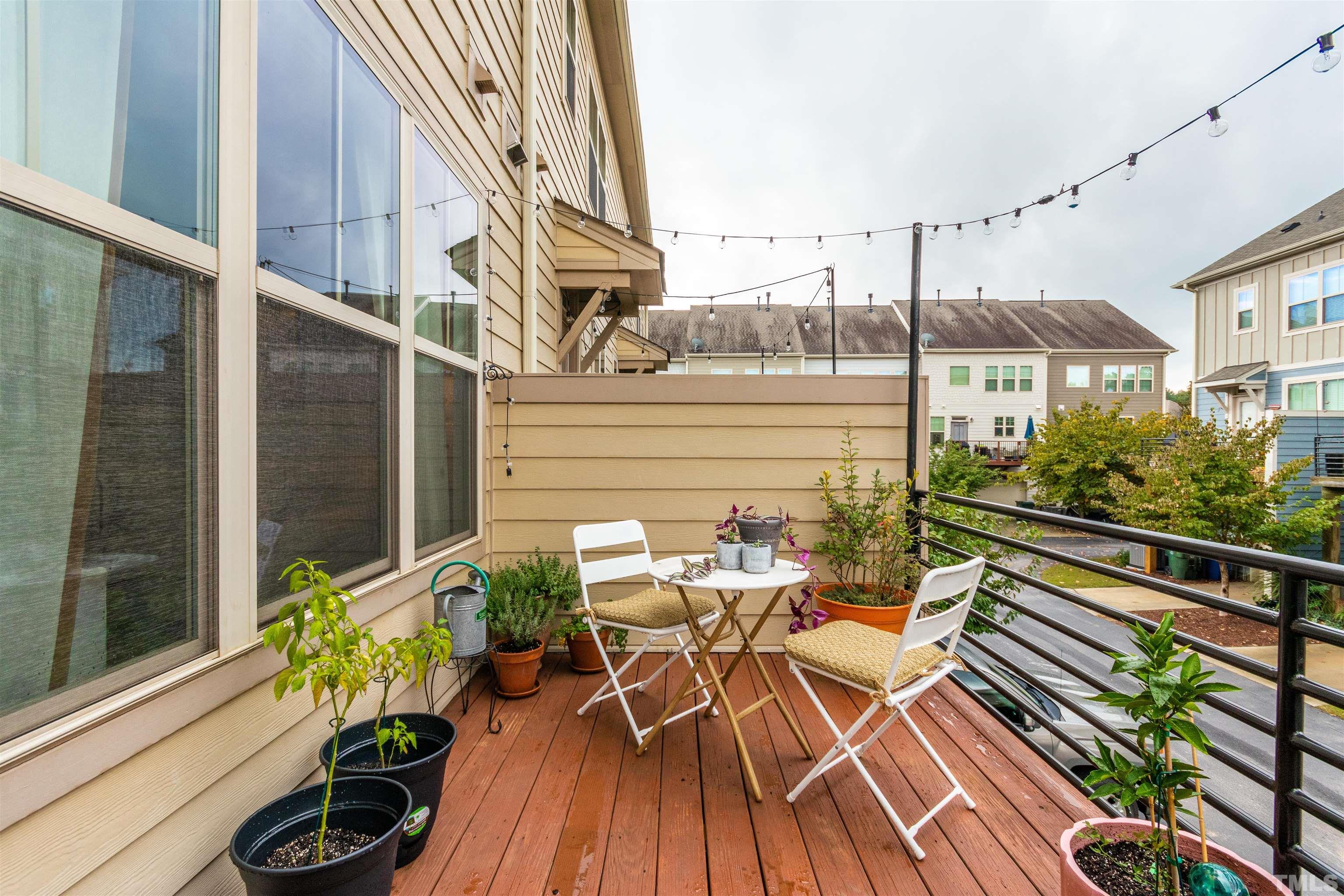 1417 Crafton Way Raleigh, NC 27607 - Photo 27 of 29 a view of balcony with chairs and wooden floor