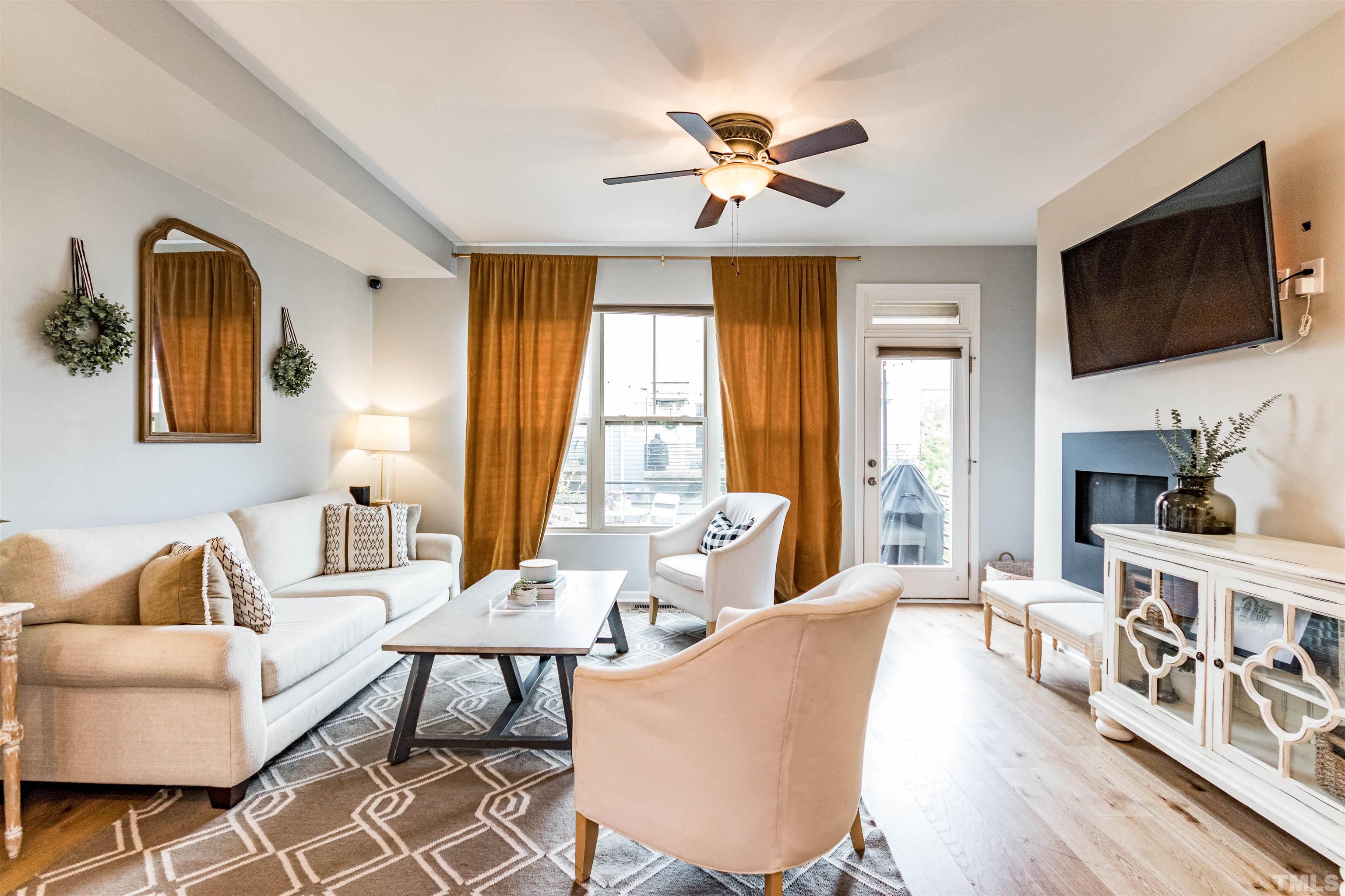 1417 Crafton Way Raleigh, NC 27607 - Photo 4 of 29 a living room with furniture fireplace and a flat screen tv