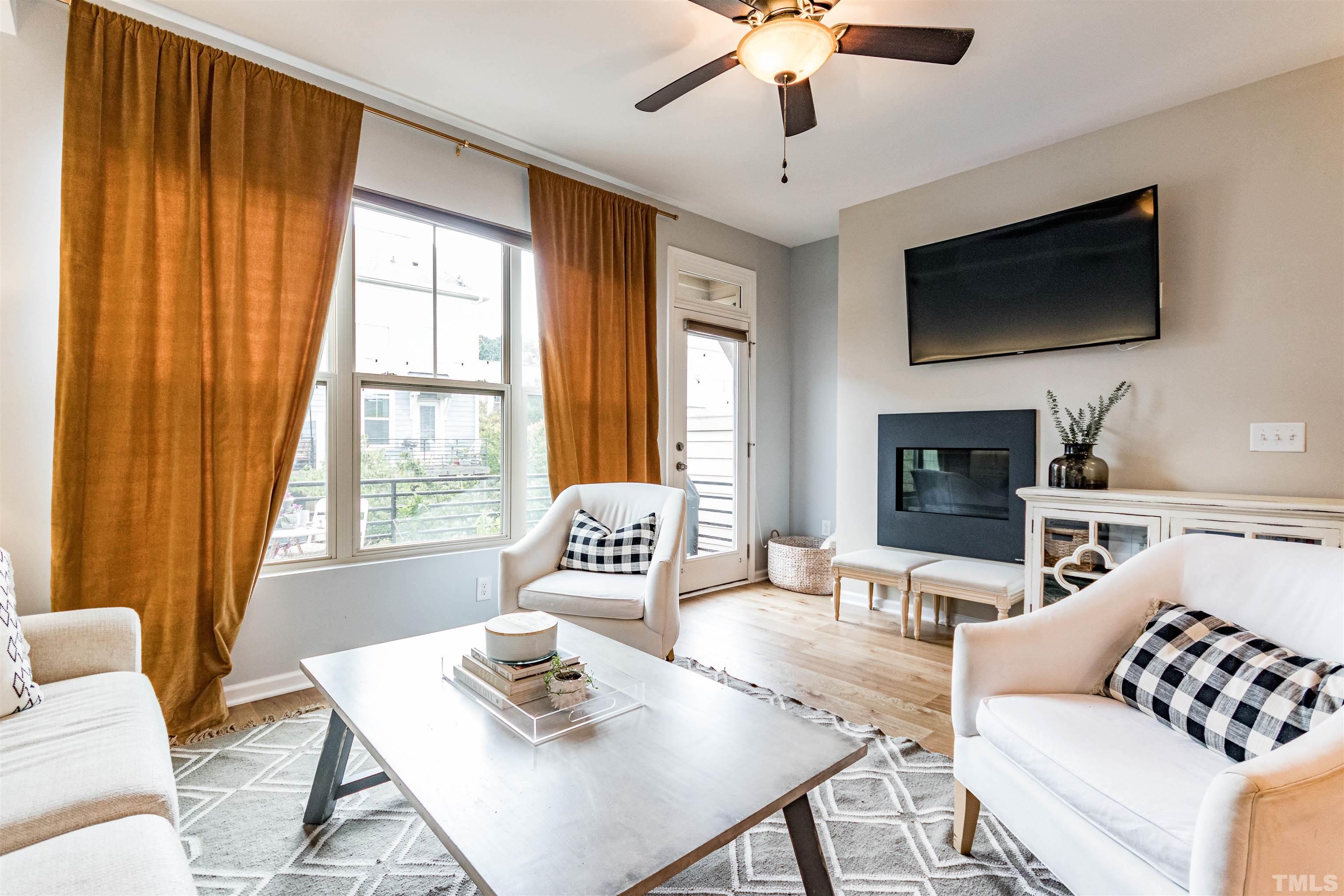 1417 Crafton Way Raleigh, NC 27607 - Photo 5 of 29 a living room with furniture a flat screen tv and a large window