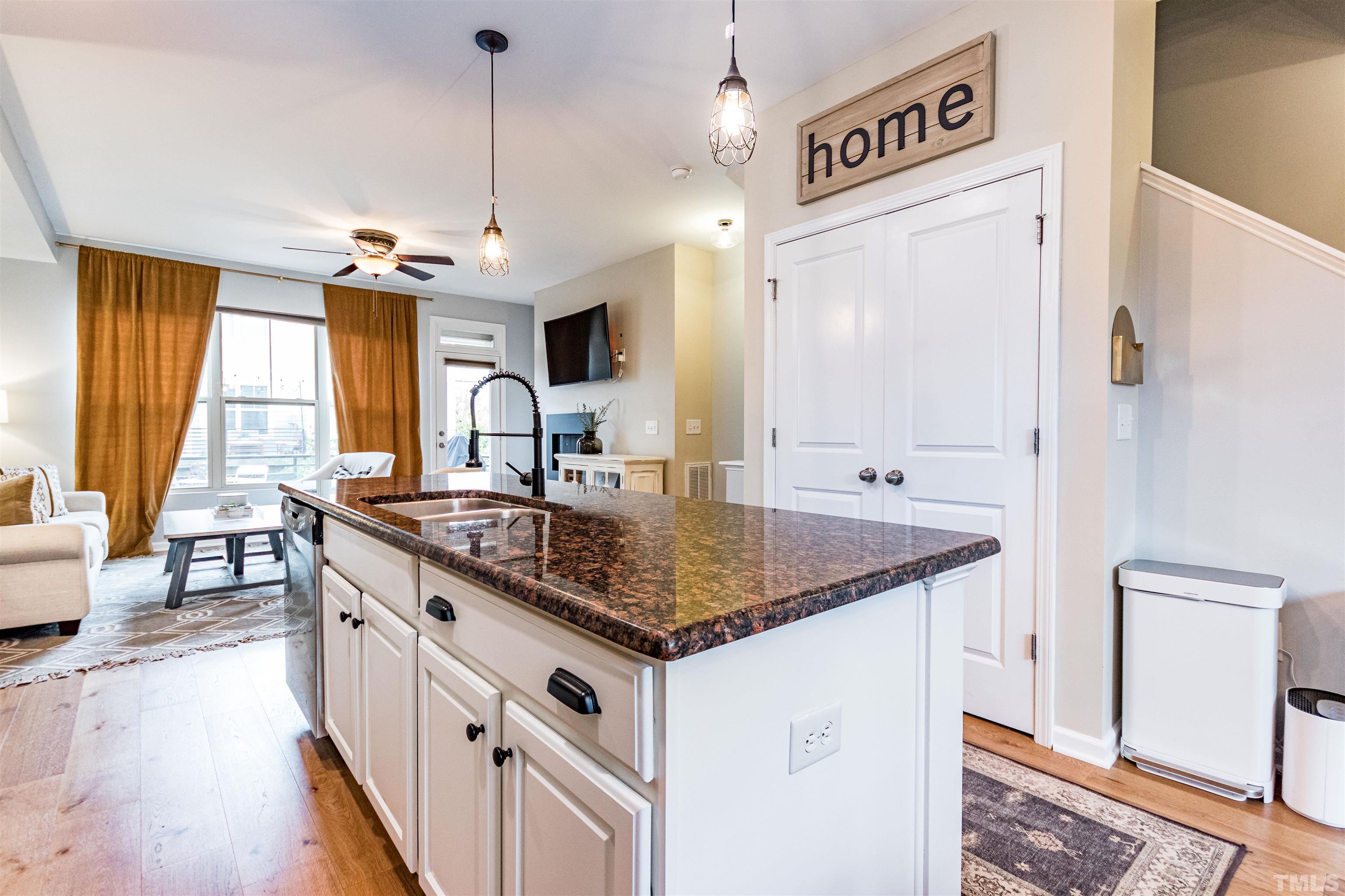 1417 Crafton Way Raleigh, NC 27607 - Photo 9 of 29 a kitchen with stainless steel appliances granite countertop a sink and a refrigerator