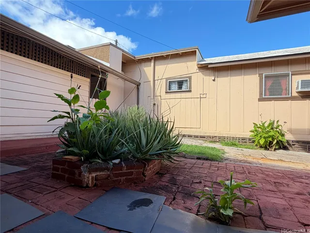 a plant is sitting in front of a house