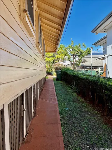 a view of a pathway of a house with a yard
