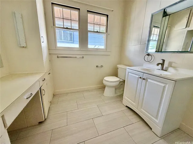 a bathroom with a sink toilet and window