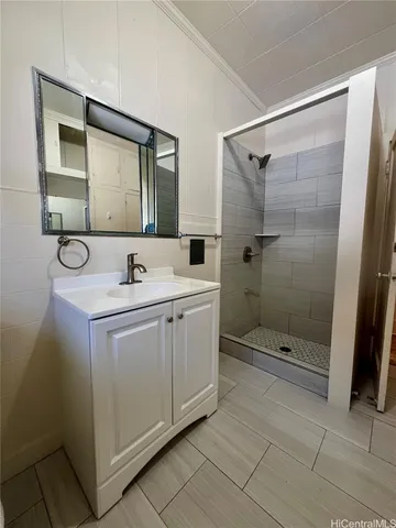 a bathroom with a shower sink and mirror