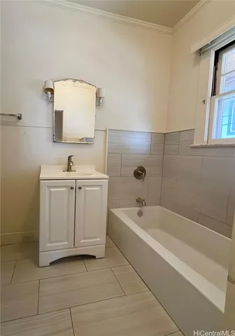 a spacious bathroom with a bathtub sink and mirror
