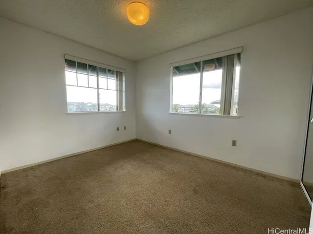 an empty room with windows and closet