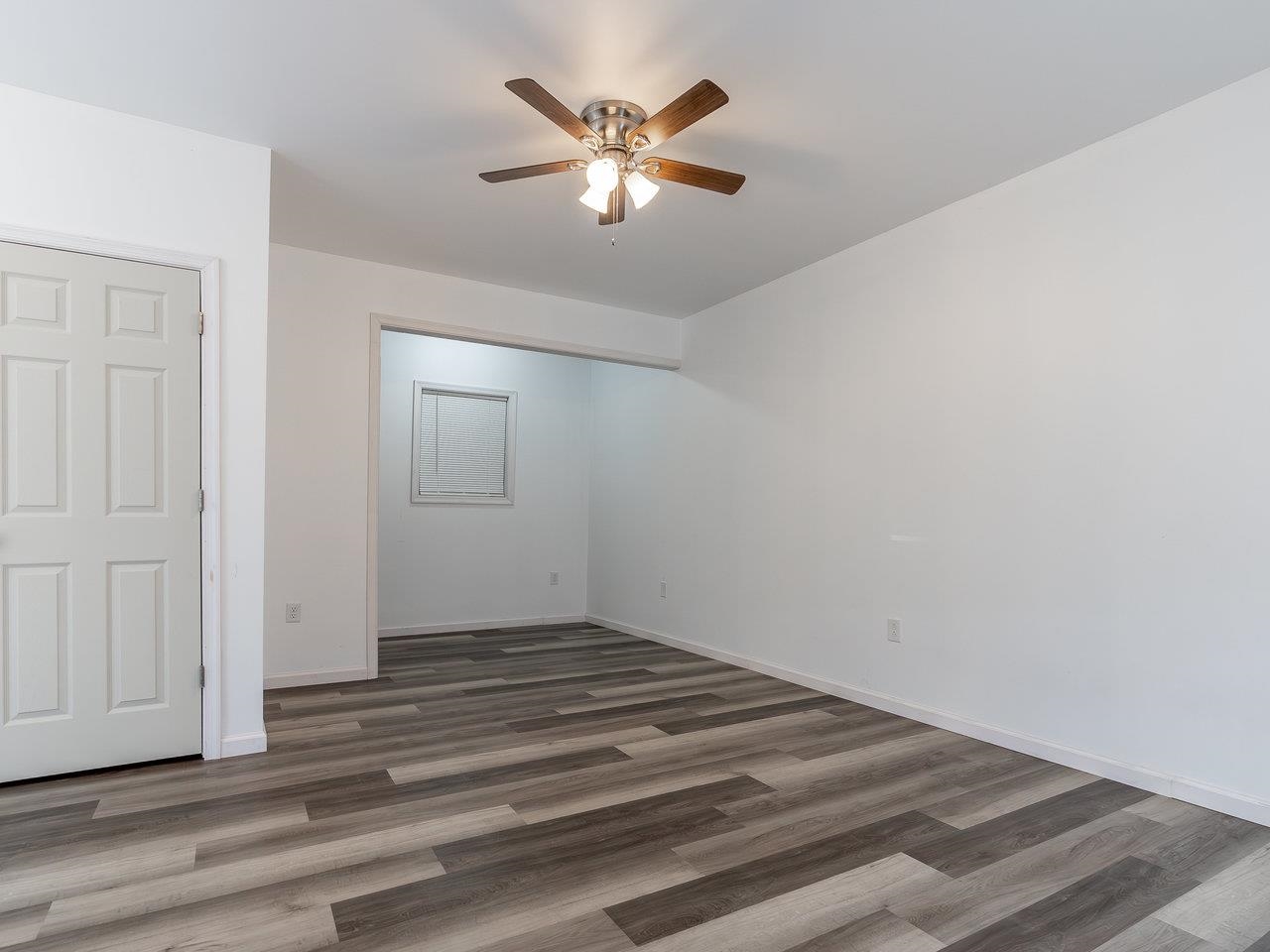 3192 Hebron Court Harrisonburg, VA 22801 - Photo 12 of 75 an empty room with wooden floor and a ceiling fan
