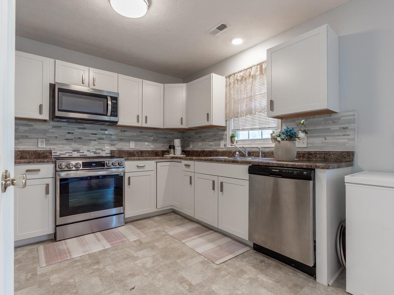 3192 Hebron Court Harrisonburg, VA 22801 - Photo 24 of 75 a kitchen with stainless steel appliances granite countertop a stove a sink and a microwave