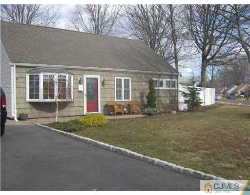 17 Markham Road Edison, NJ 08817 - Photo 1 of 13 a front view of a house with a yard and garage