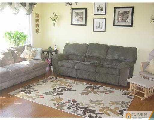17 Markham Road Edison, NJ 08817 - Photo 4 of 13 a living room with furniture window and a wooden floor
