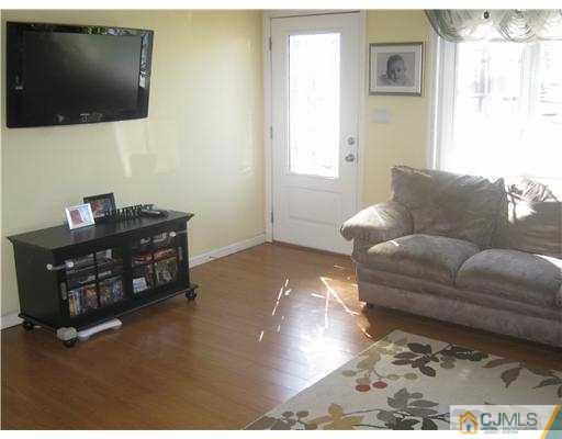 17 Markham Road Edison, NJ 08817 - Photo 5 of 13 a living room with furniture and a flat screen tv