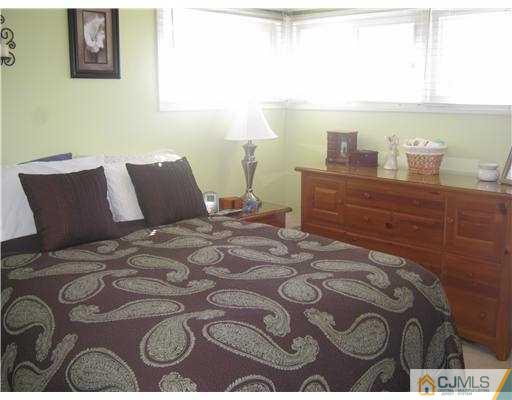 17 Markham Road Edison, NJ 08817 - Photo 7 of 13 a bedroom with a bed and wooden floor