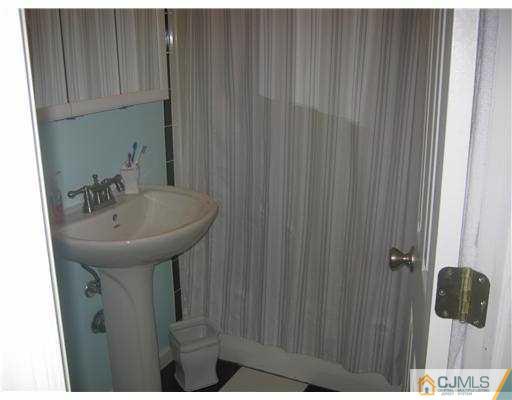 17 Markham Road Edison, NJ 08817 - Photo 10 of 13 a bathroom with a sink and mirror
