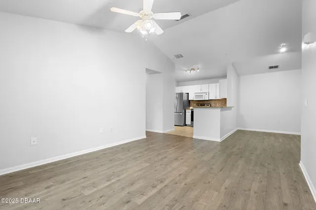 a view of a kitchen with a dishwasher cabinets and wooden floor