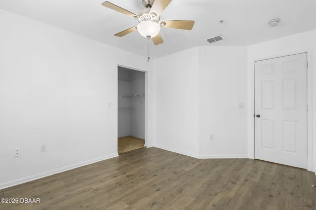 a view of an empty room with a fan