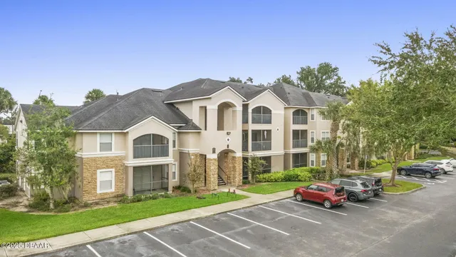 a front view of a house with a garden and entertaining space