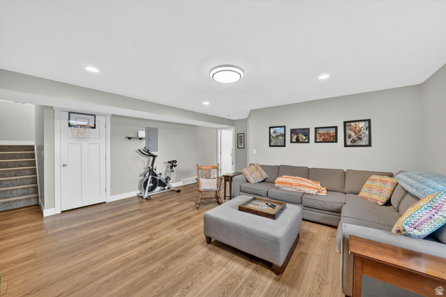 7872 Farm House Lane Midvale, UT 84047 - Photo 28 of 39 Finished basement featuring wood-finish flooring, recessed lighting, a built-in staircase, and painted walls