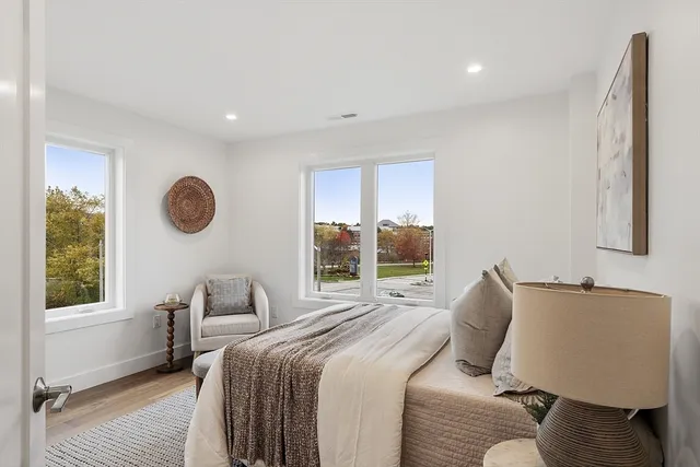 a bedroom with a large bed and a window