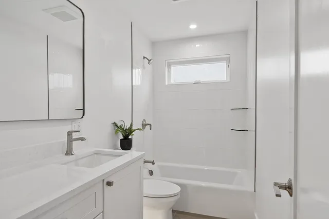 a bedroom with bed and windows