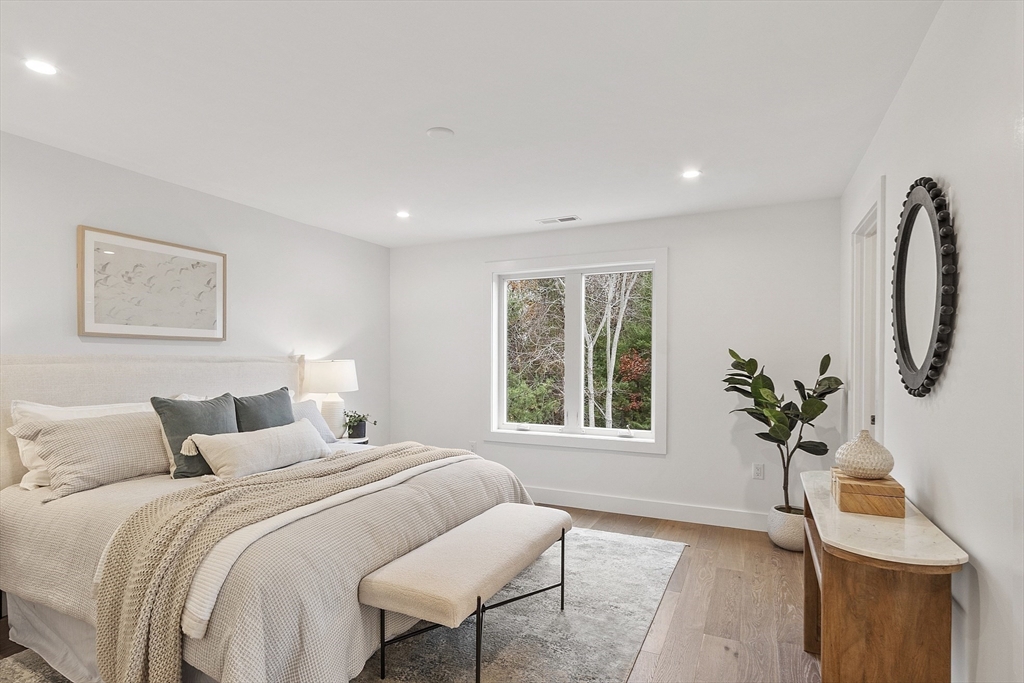 225 Middlesex Turnpike, Unit 106 Burlington, MA 01803 - Photo 17 of 23 a bedroom with bed and windows